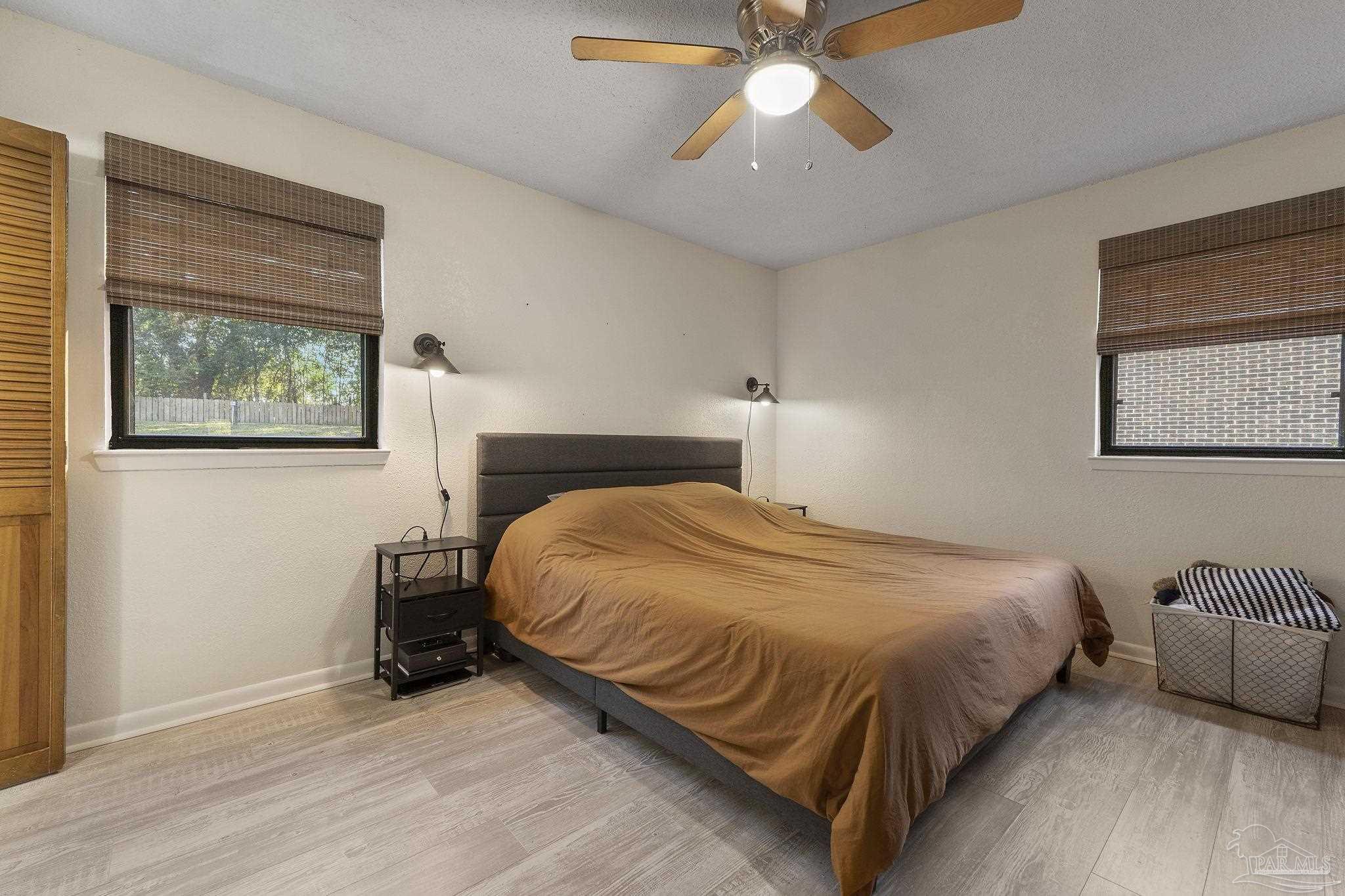 465 Ronda Street Pensacola, FL 32534 - Photo 21 of 48 a bedroom with a bed and a chandelier