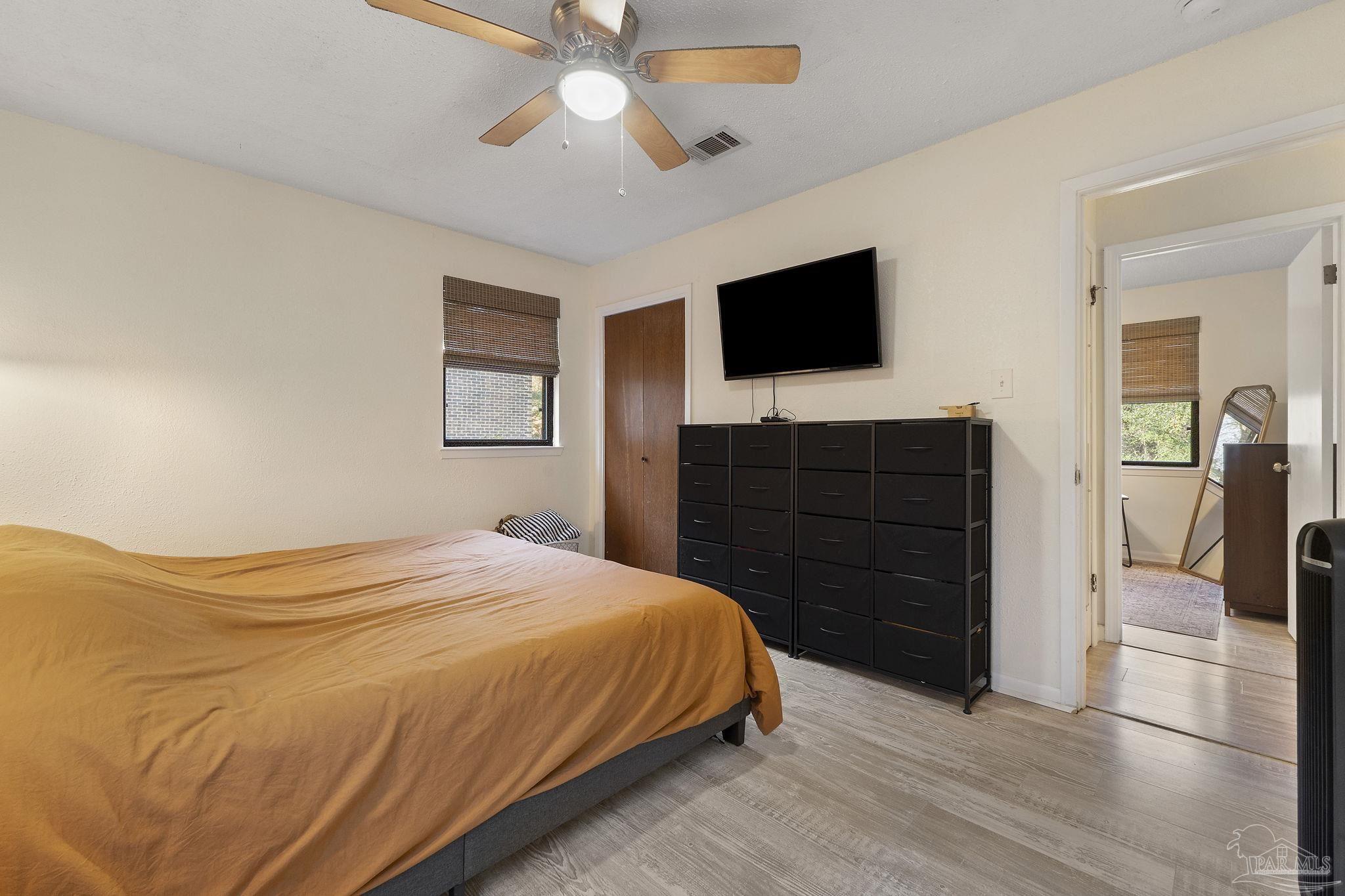 465 Ronda Street Pensacola, FL 32534 - Photo 22 of 48 a bedroom with a bed and a flat screen tv