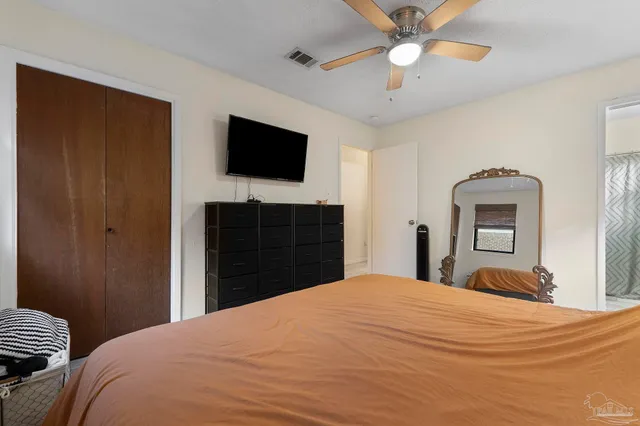 a bedroom with a bed and a flat screen tv