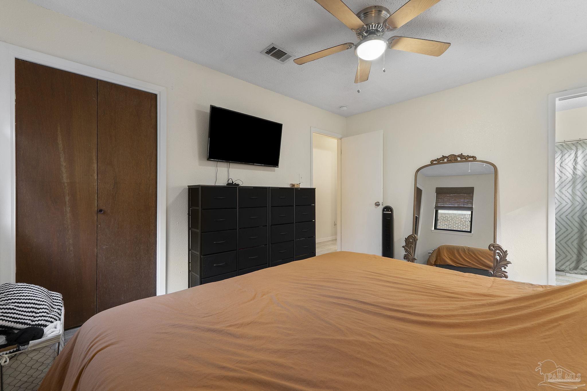 465 Ronda Street Pensacola, FL 32534 - Photo 23 of 48 a bedroom with a bed and a flat screen tv