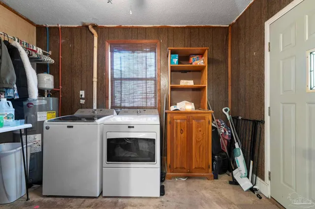 a view of a storage and utility room with washer and dryer