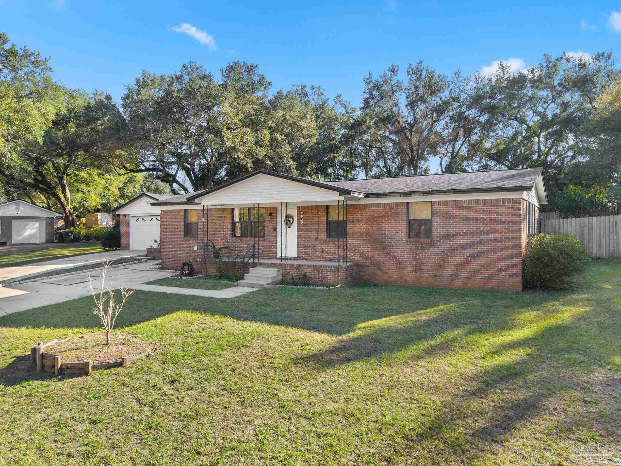 465 Ronda Street Pensacola, FL 32534 - Photo 3 of 48 a view of a house with backyard and trees