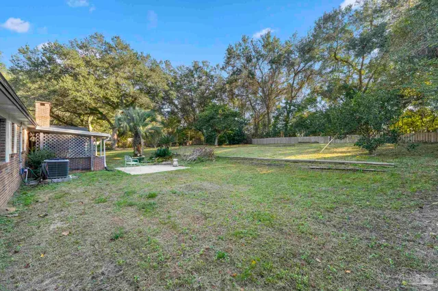 a view of a house with a yard and sitting area