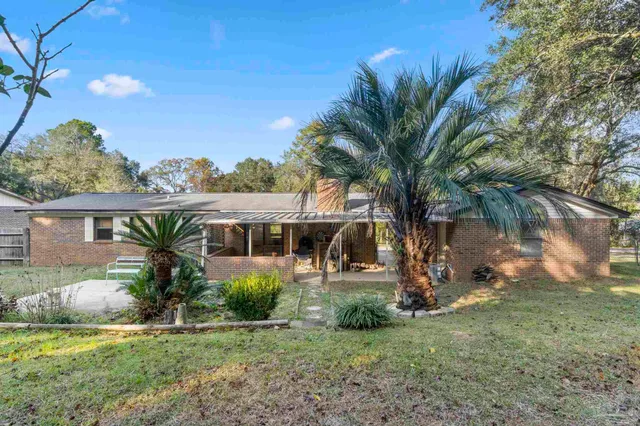 a front view of house with yard and outdoor seating
