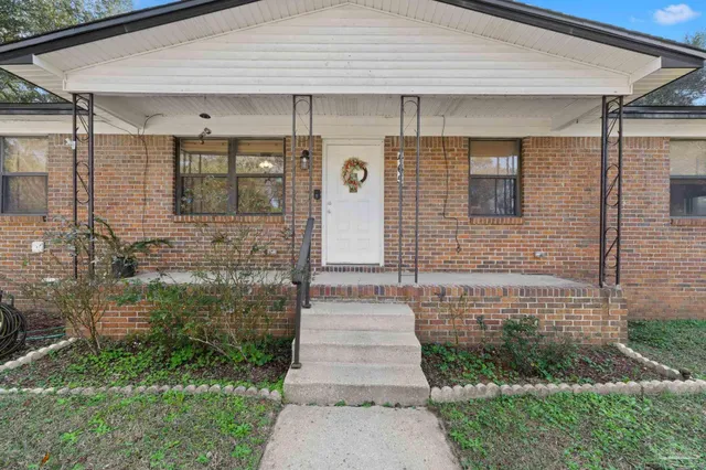 a front view of a house with garden