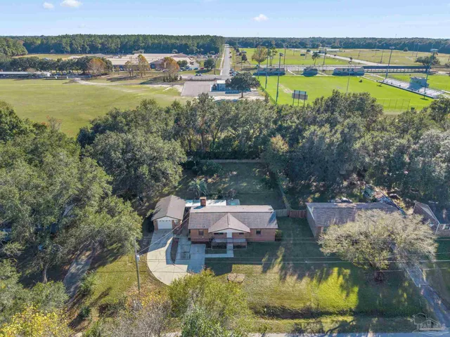 a view of a lake with a mountain and a yard