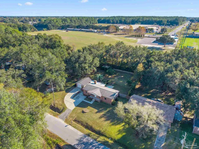 an aerial view of a house with a yard and lake view