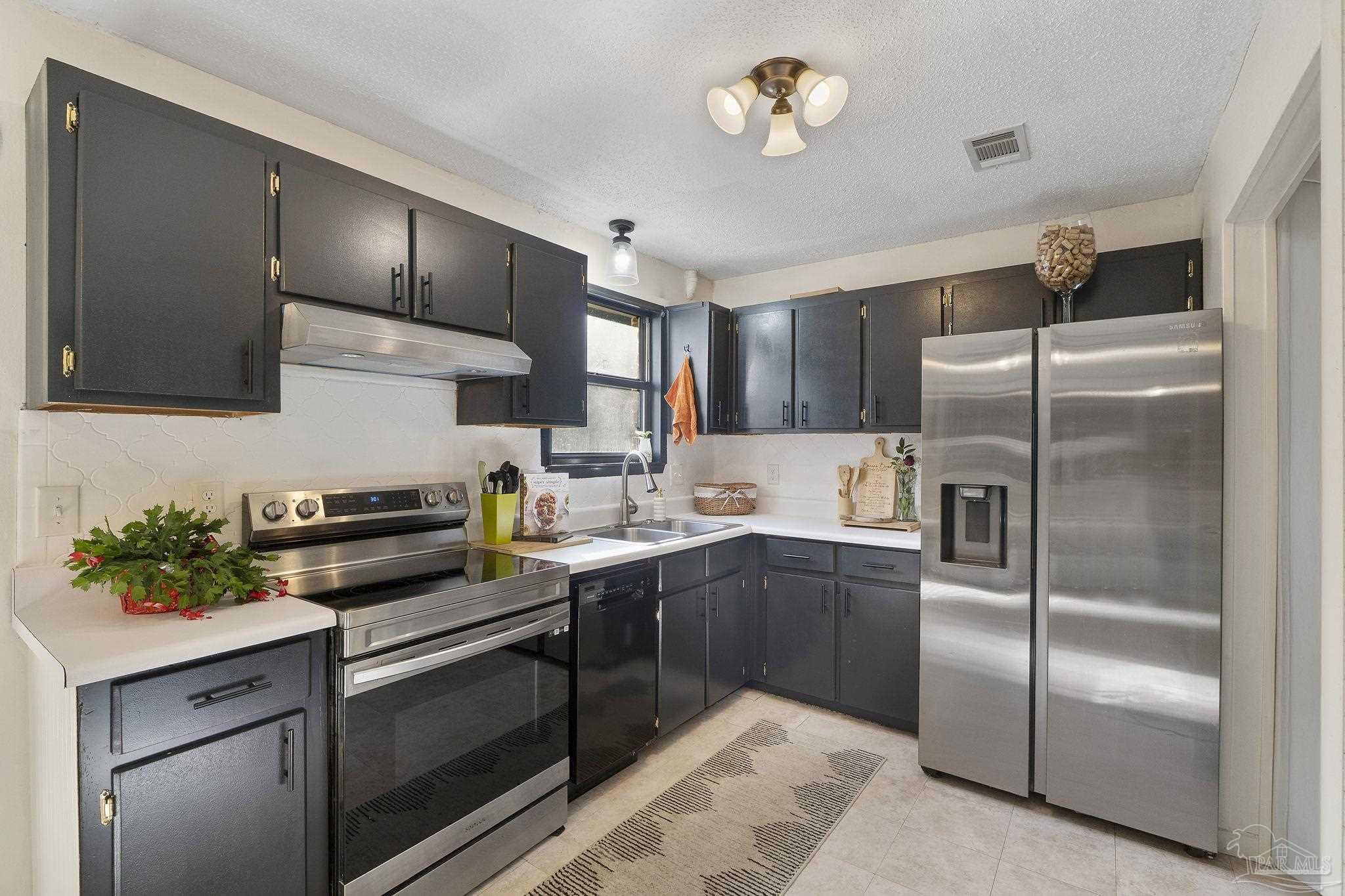 465 Ronda Street Pensacola, FL 32534 - Photo 10 of 48 a kitchen with cabinets stainless steel appliances and a counter space