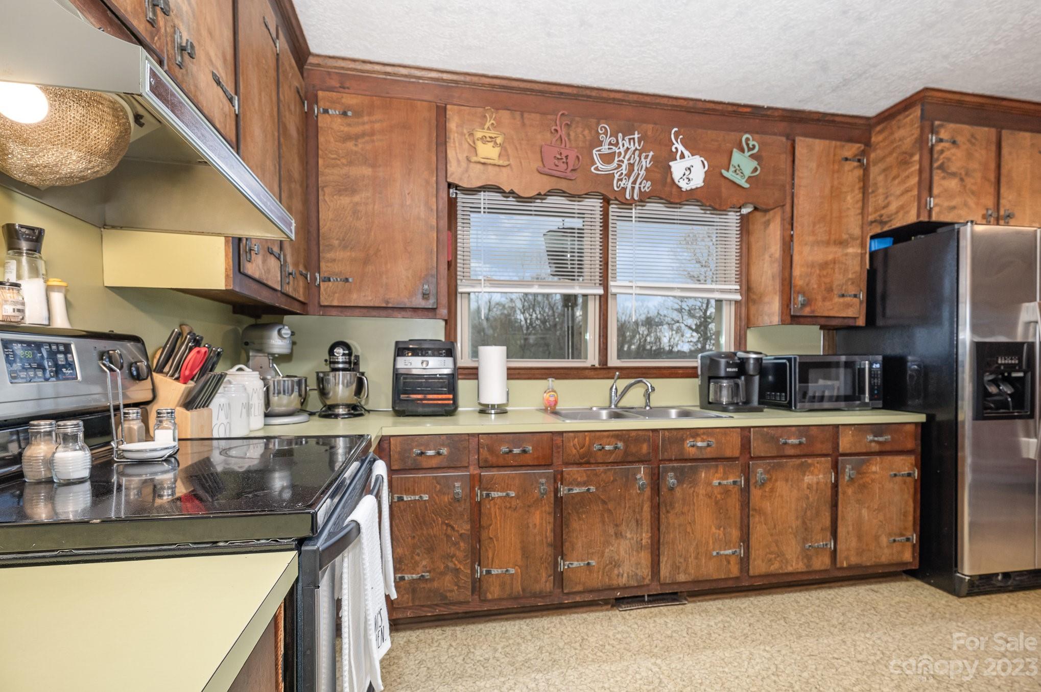 835 Parks Road Woodleaf, NC 27054 - Photo 11 of 28 a kitchen with stainless steel appliances granite countertop a sink and cabinets