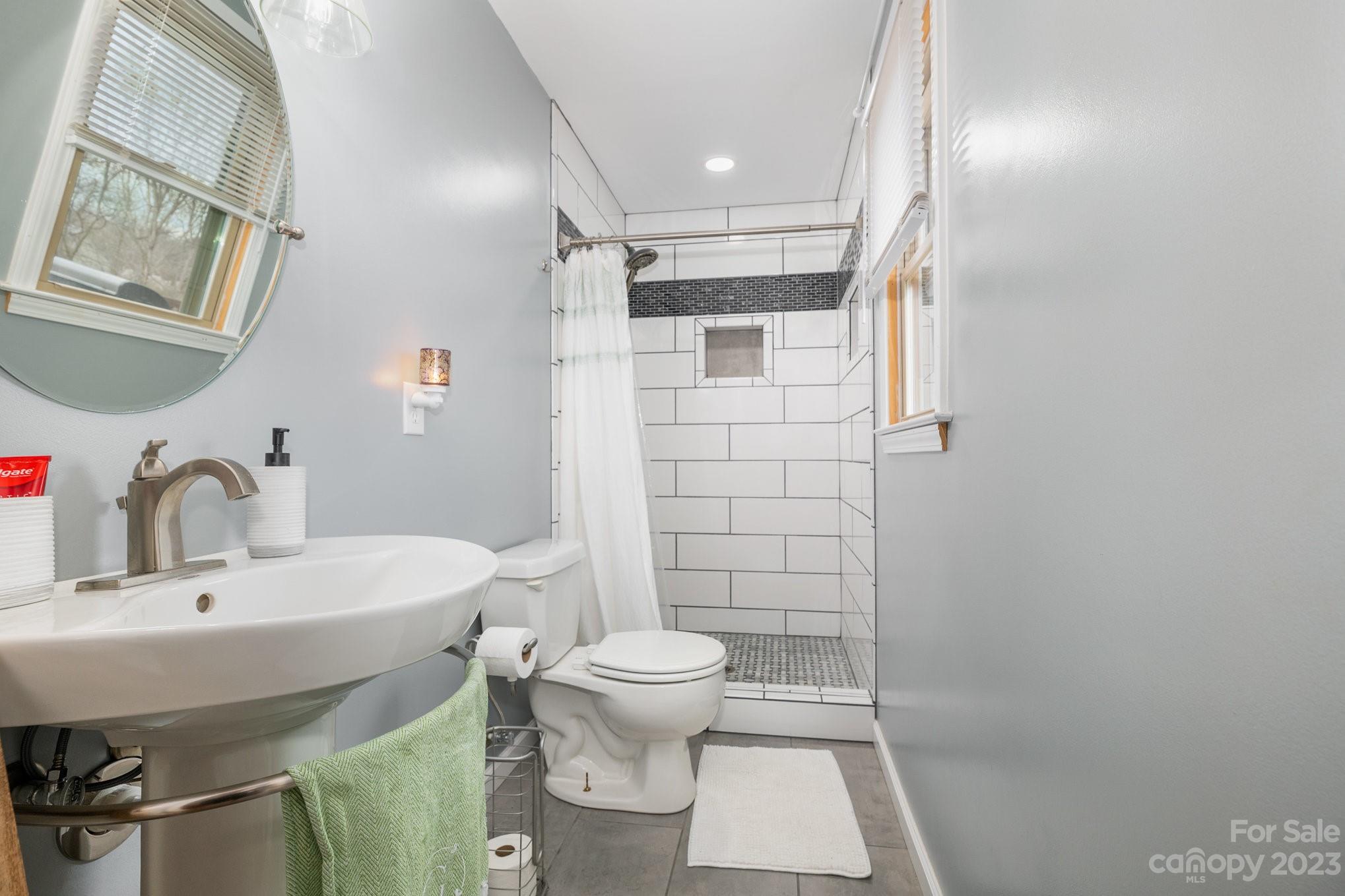 835 Parks Road Woodleaf, NC 27054 - Photo 16 of 28 a bathroom with a sink toilet and shower