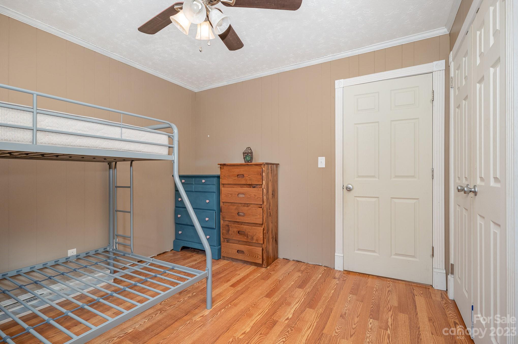 835 Parks Road Woodleaf, NC 27054 - Photo 20 of 28 a bedroom with a bed and a chair