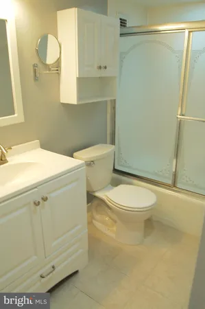 a white toilet sitting next to a bathroom sink