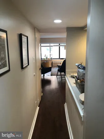 a view of a hallway with furniture and floor to ceiling window