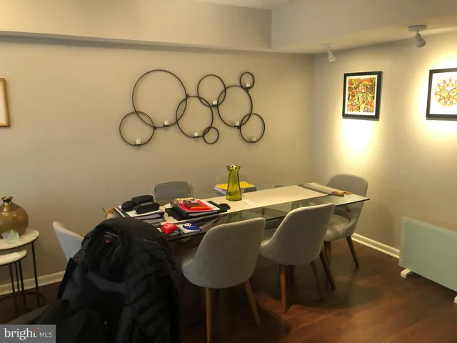 a dining room with window and wooden floor