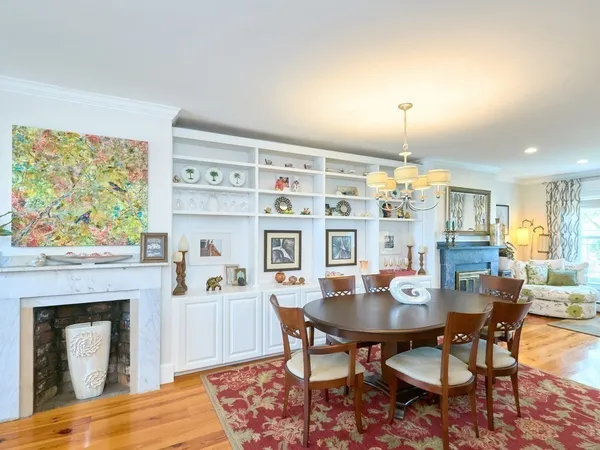 a view of a dining room with furniture and chandelier
