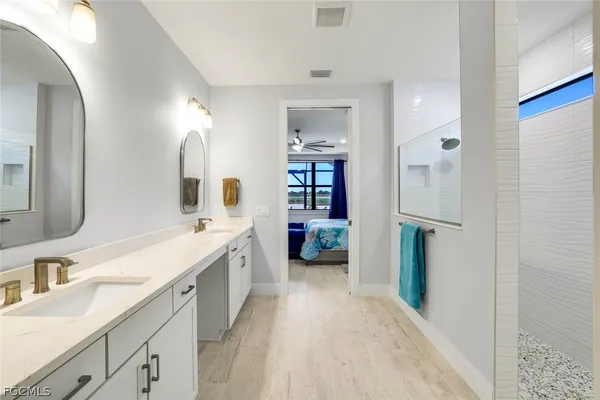 a large bathroom with a double vanity sink and a mirror