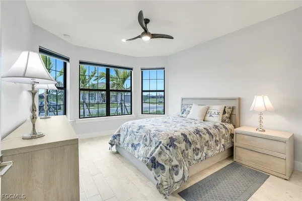 a bedroom with a large bed and a large window