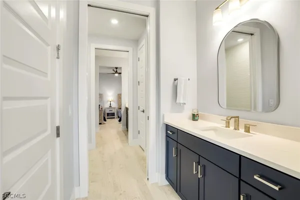 a en suite bathroom with a double vanity sink and a mirror