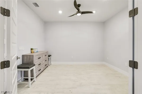 a bedroom with a bed and cabinets