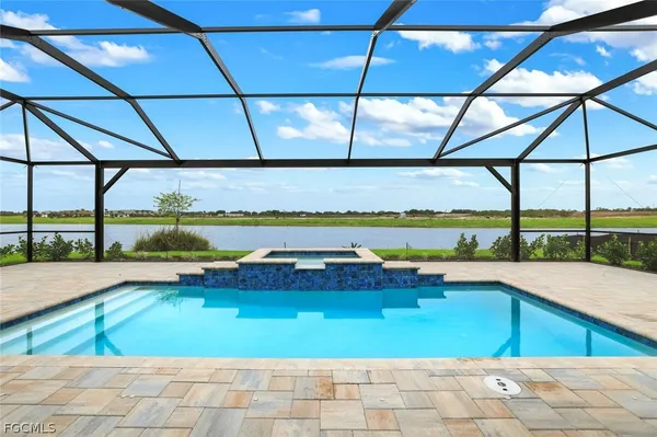 a view of swimming pool with outdoor seating and outdoor shower