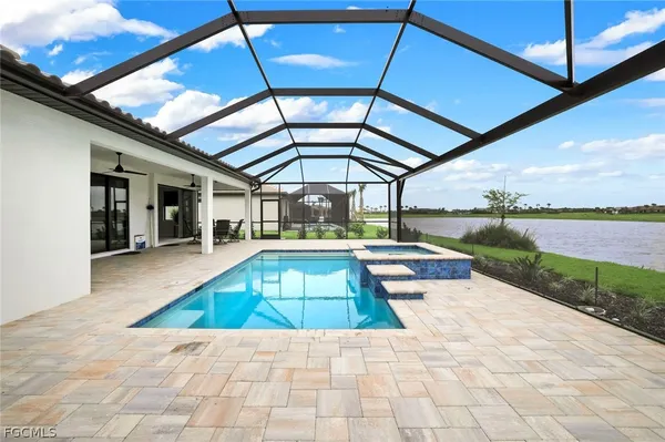 a view of swimming pool with a patio and a yard