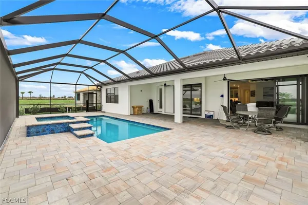 a view of a patio with a table and chairs under an umbrella
