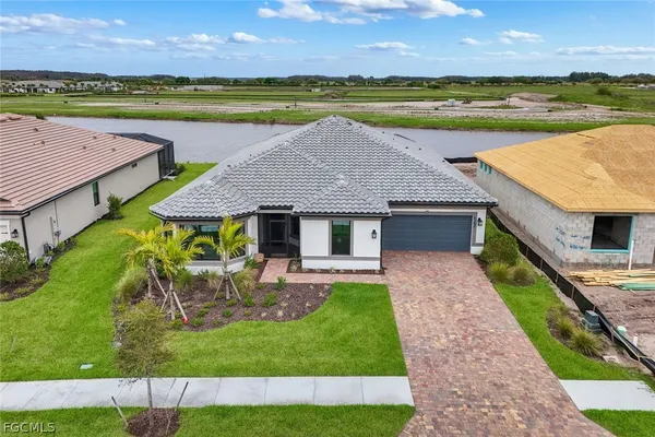 an aerial view of a house with a garden and a swimming pool