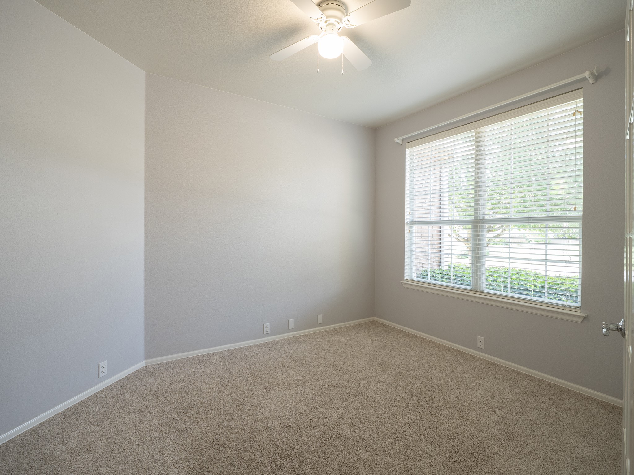 572 Big Meadow Road Austin, TX 78737 - Photo 12 of 32 A tranquil interior space featuring a window with natural illumination and soft carpeting.