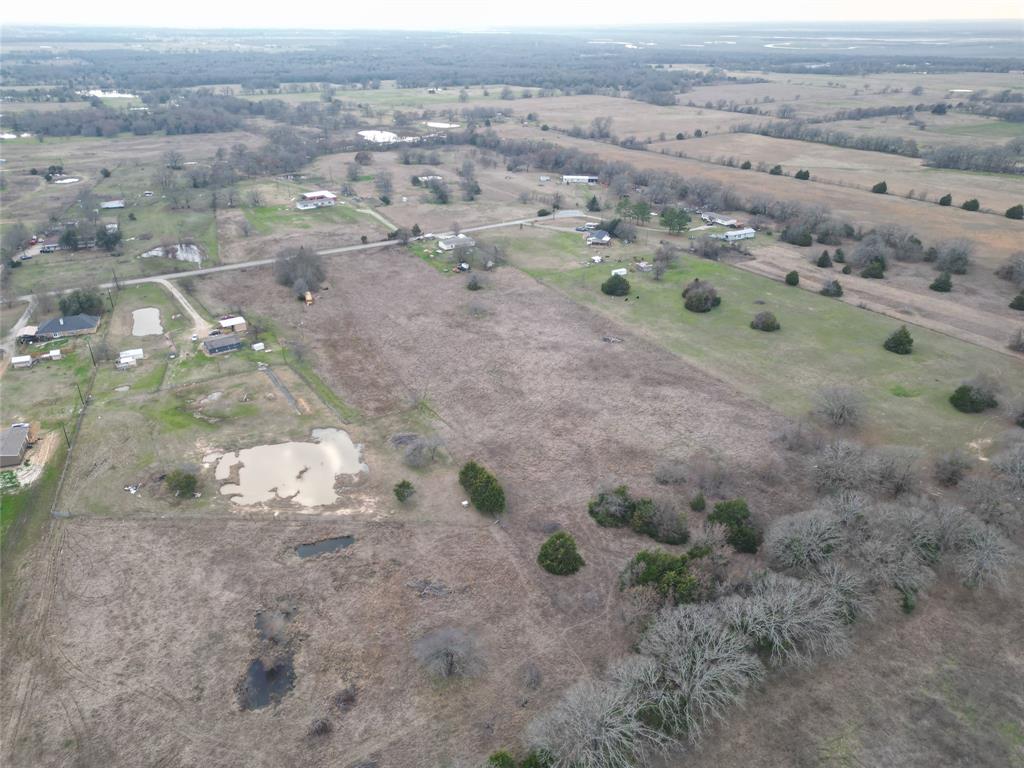Lot 9 Acorn Circle Scurry, TX 75158 - Photo 7 of 9 a view of a dry yard with trees