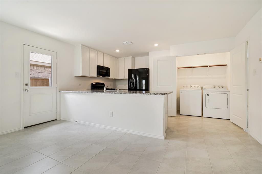 1345 Cider Street Forney, TX 75126 - Photo 5 of 15 a view of a kitchen with refrigerator and a sink