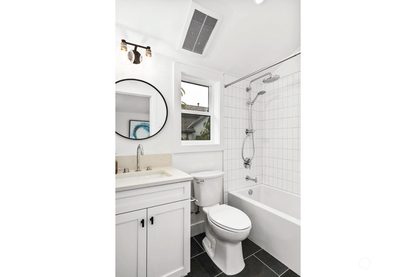 533 North 71st Street, Unit B Seattle, WA 98103 - Photo 16 of 23 a bathroom with a toilet sink a mirror and shower