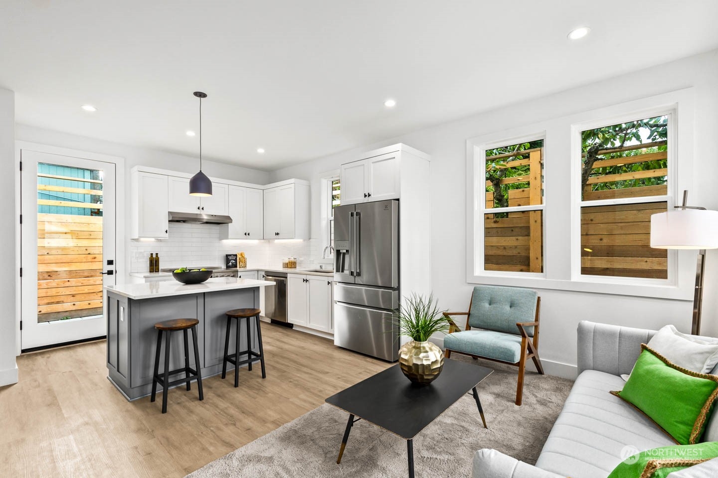 533 North 71st Street, Unit B Seattle, WA 98103 - Photo 2 of 23 a kitchen with a refrigerator a dining table and chairs