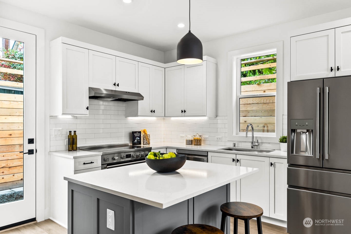 533 North 71st Street, Unit B Seattle, WA 98103 - Photo 4 of 23 a kitchen with stainless steel appliances a sink a stove a refrigerator cabinets and a window