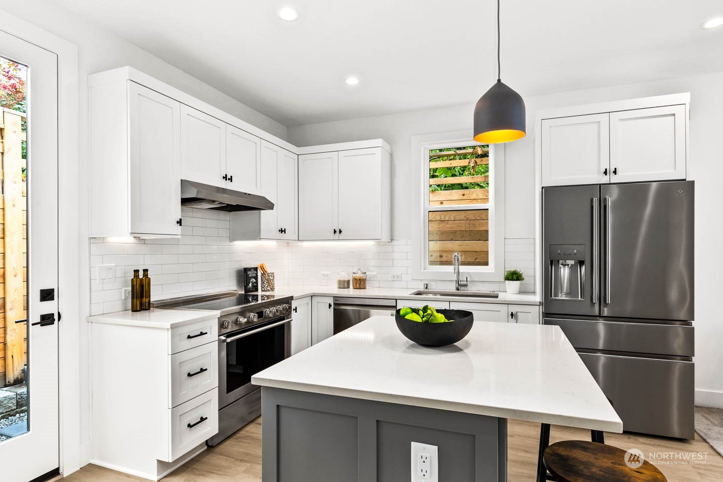 533 North 71st Street, Unit B Seattle, WA 98103 - Photo 5 of 23 a kitchen with stainless steel appliances a sink a stove a refrigerator a counter space and cabinets