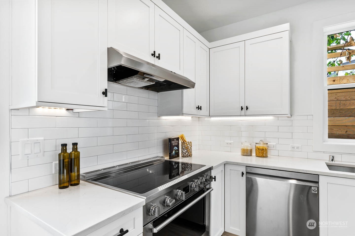 533 North 71st Street, Unit B Seattle, WA 98103 - Photo 6 of 23 a kitchen with stainless steel appliances granite countertop a sink stove and white cabinets