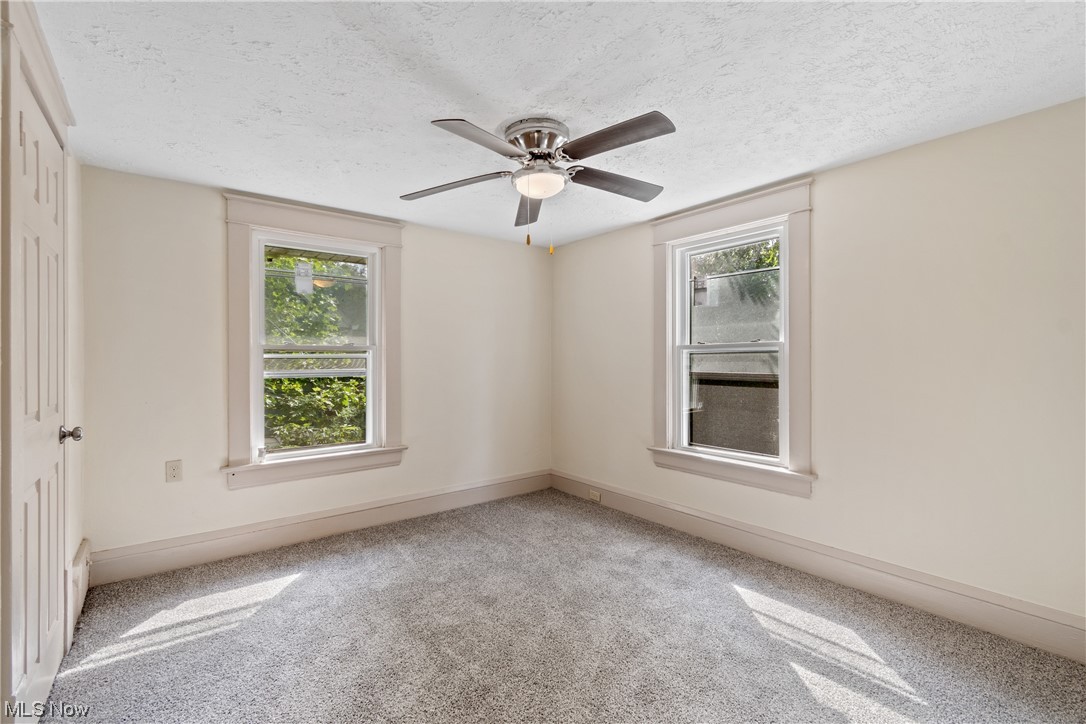 1474 Hampton Road Akron, OH 44305 - Photo 21 of 27 Unfurnished room with a textured ceiling, light carpet, and ceiling fan