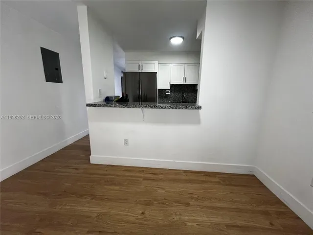 a view of kitchen with stainless steel appliances granite countertop a sink and a stove top oven
