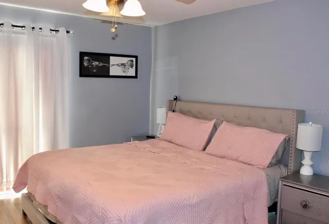 a large bed in a bedroom next to a window