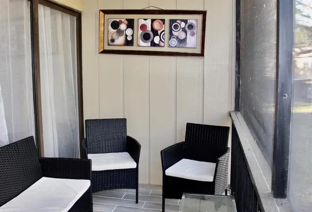 a view of a hallway with furniture and wooden floor