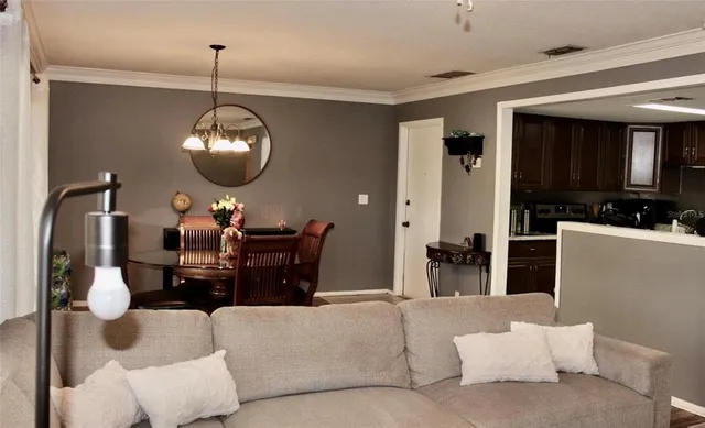 a living room with furniture and a chandelier