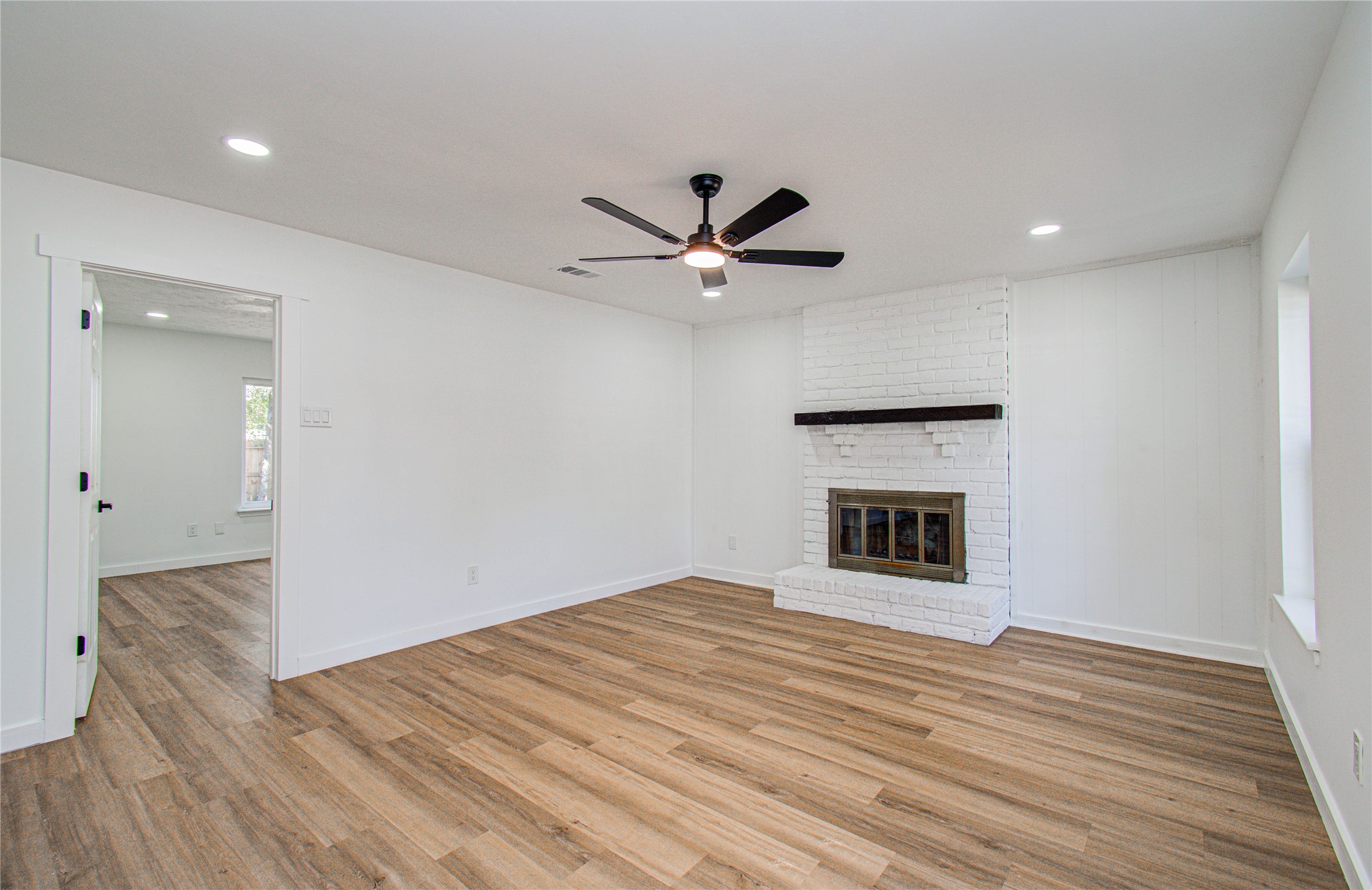 23319 Whispering Willow Drive Spring, TX 77373 - Photo 22 of 41 a view of an empty room with wooden floor and a ceiling fan