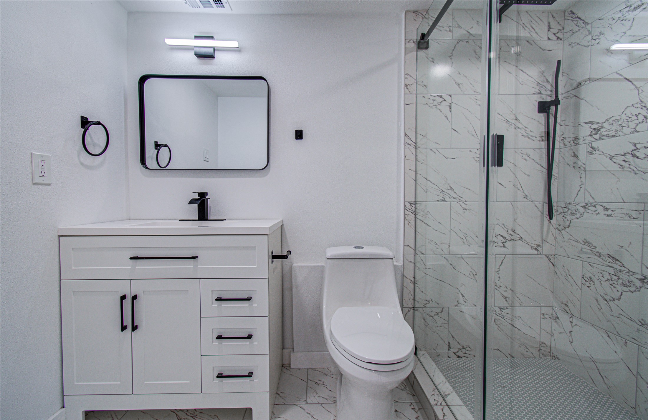23319 Whispering Willow Drive Spring, TX 77373 - Photo 30 of 41 a bathroom with a toilet sink vanity and mirror