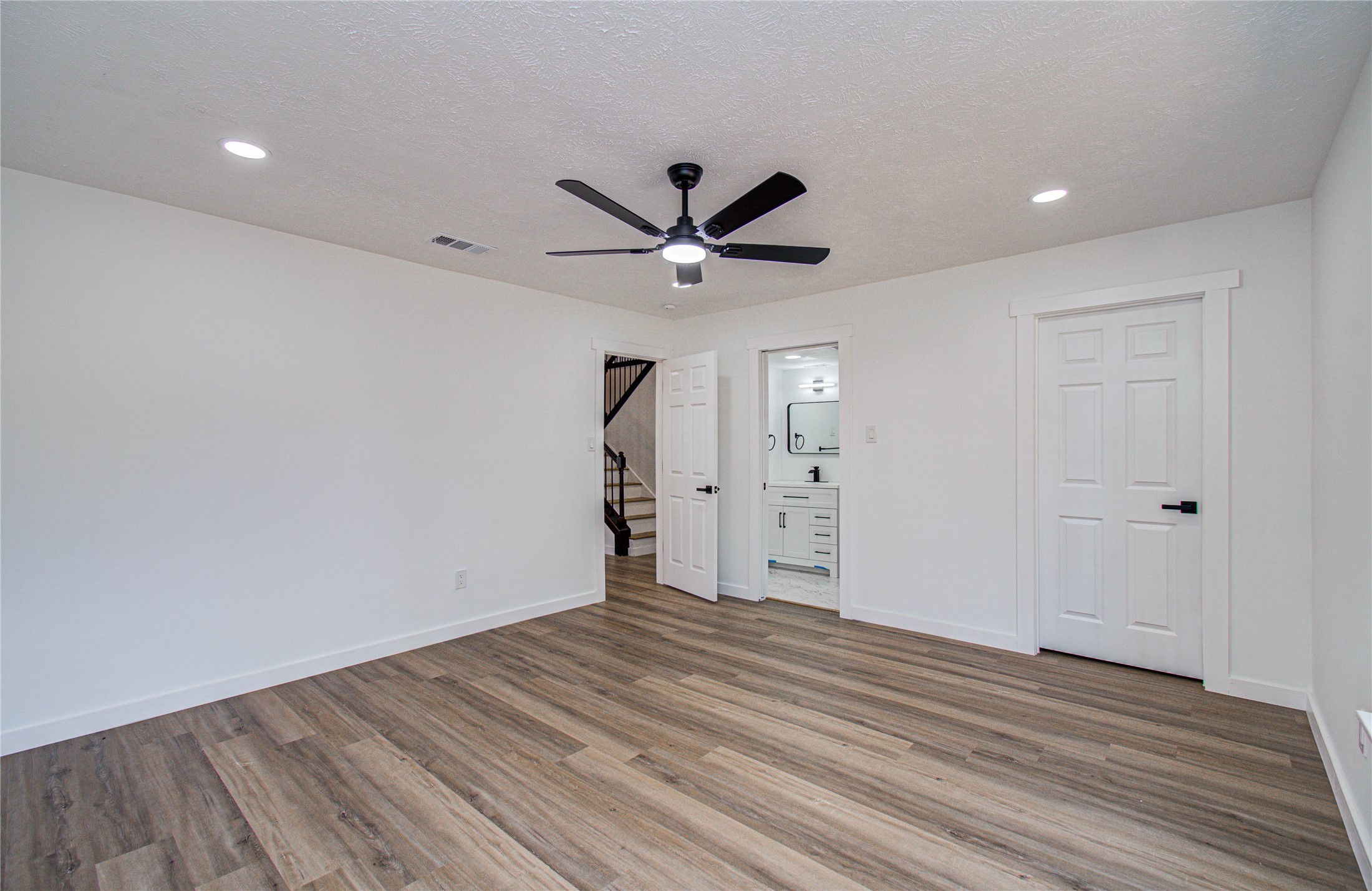 23319 Whispering Willow Drive Spring, TX 77373 - Photo 35 of 41 wooden floor in an empty room with a ceiling fan
