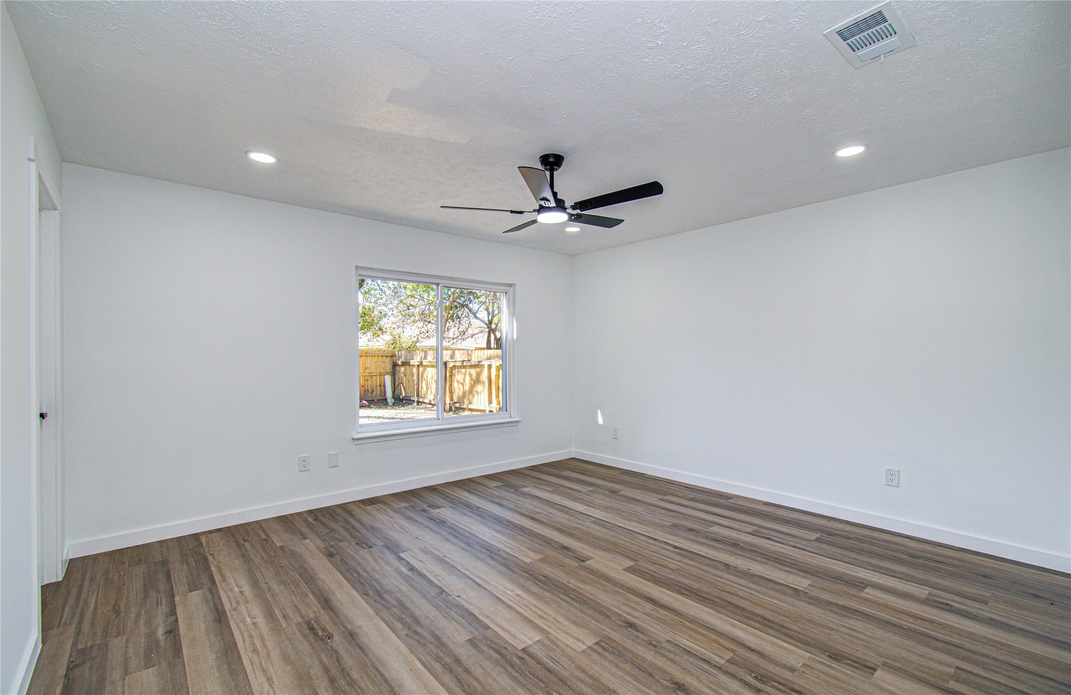 23319 Whispering Willow Drive Spring, TX 77373 - Photo 39 of 41 wooden floor in an empty room with a window