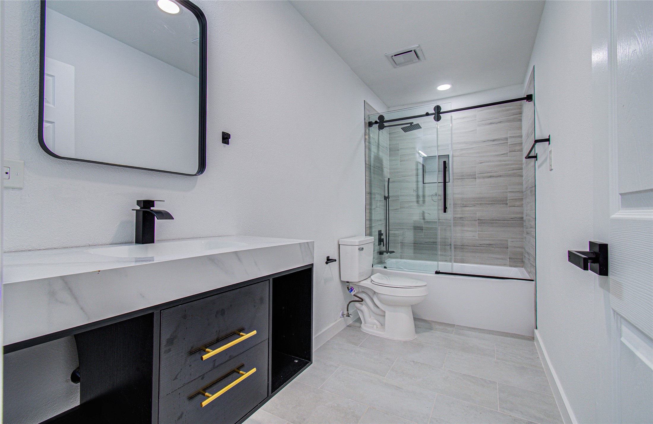 23319 Whispering Willow Drive Spring, TX 77373 - Photo 41 of 41 a bathroom with a bathtub shower sink vanity and toilet