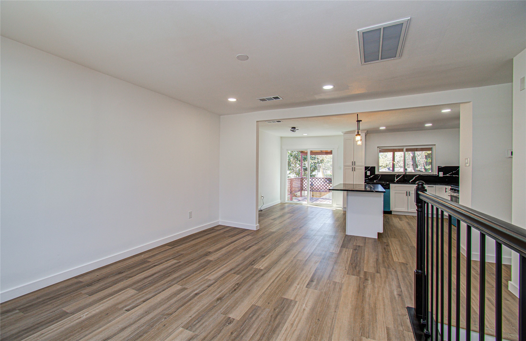 23319 Whispering Willow Drive Spring, TX 77373 - Photo 8 of 41 a view of a living room and kitchen with stainless steel appliances wooden floors