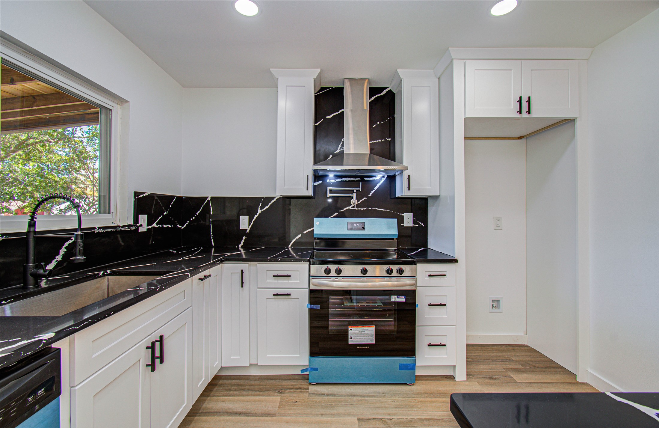 23319 Whispering Willow Drive Spring, TX 77373 - Photo 9 of 41 a kitchen with granite countertop a stove and a sink