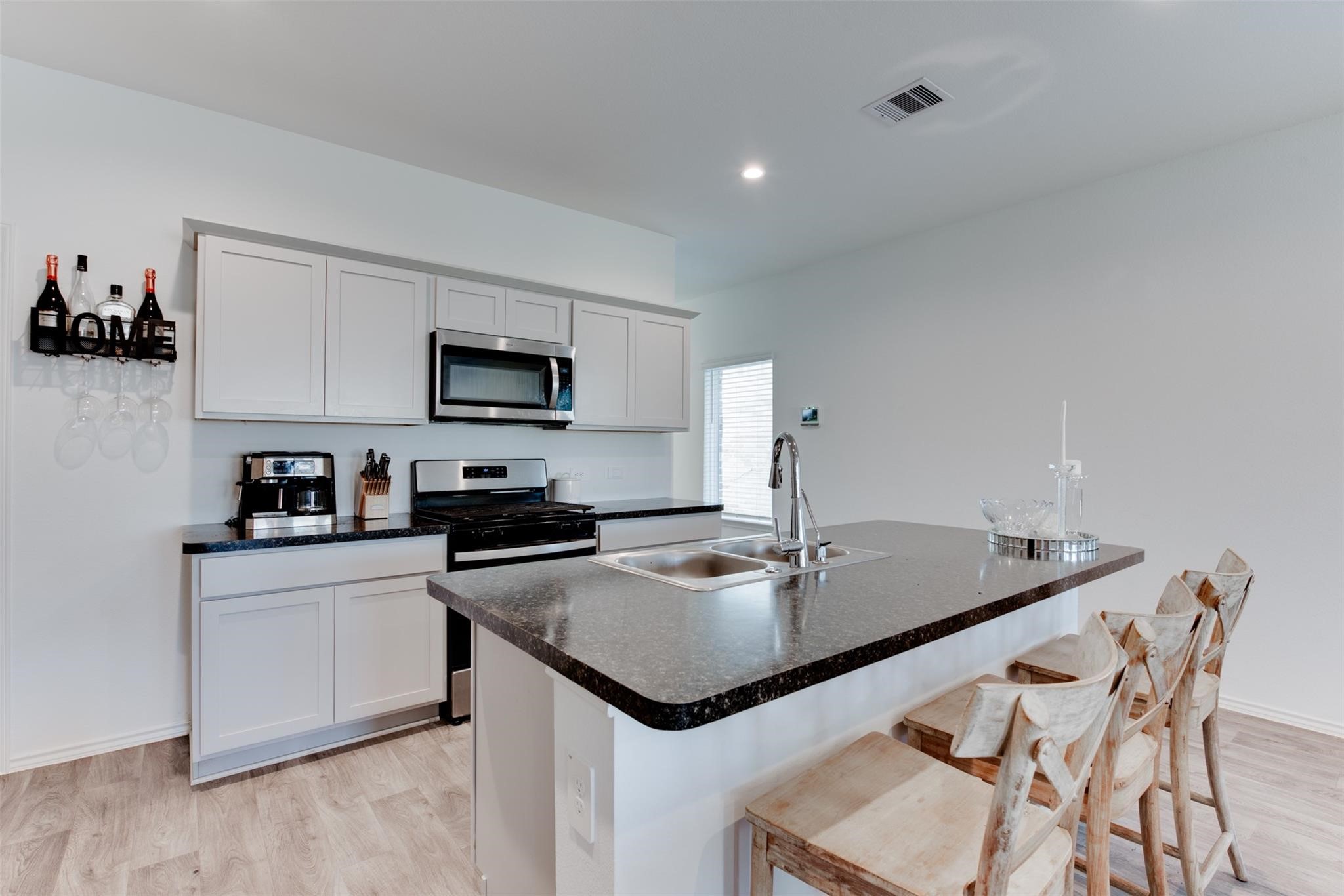 5339 Tuscany Hills Lane Spring, TX 77373 - Photo 10 of 28 a kitchen with stainless steel appliances granite countertop a sink a stove and center island