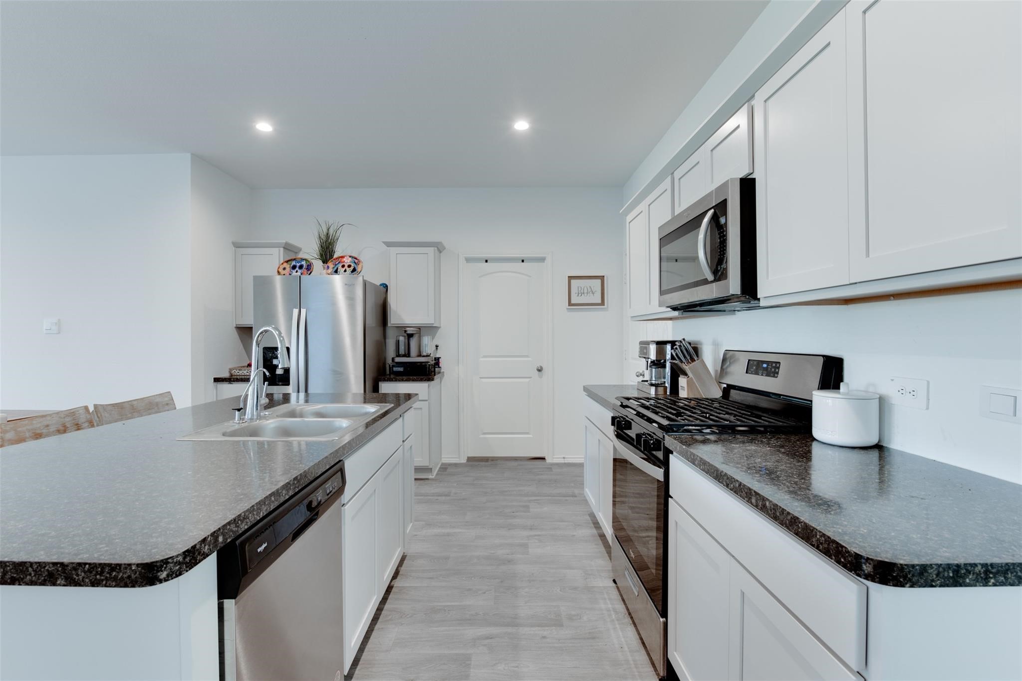 5339 Tuscany Hills Lane Spring, TX 77373 - Photo 12 of 28 a kitchen with granite countertop a sink a stove and cabinets