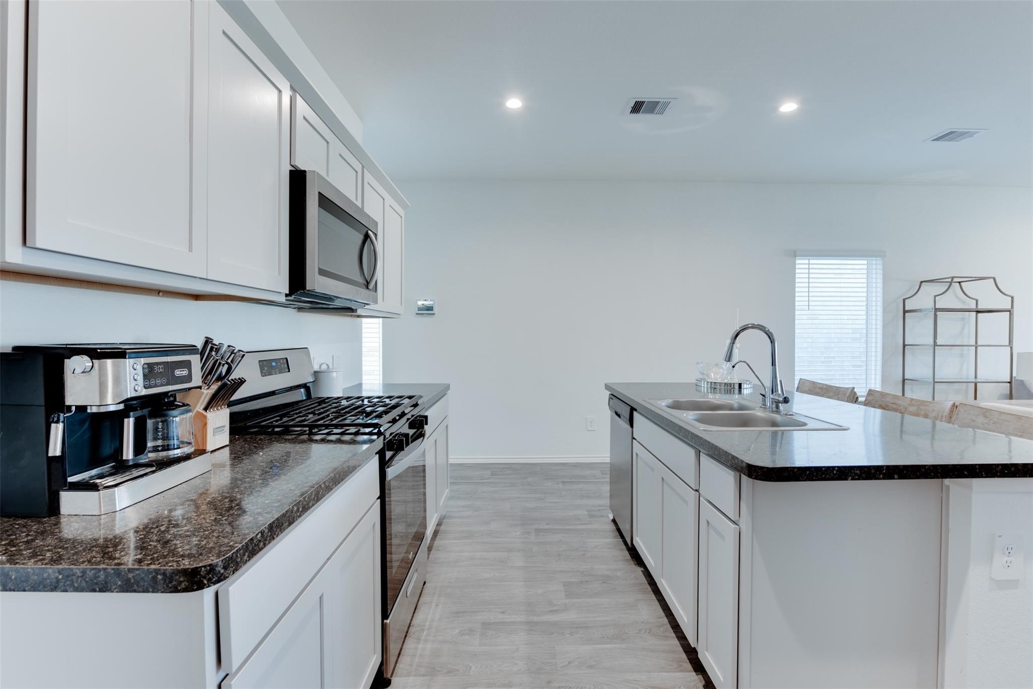 5339 Tuscany Hills Lane Spring, TX 77373 - Photo 13 of 28 a kitchen with stainless steel appliances granite countertop a sink stove and cabinets